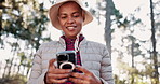 Hiking, smartphone and black woman with nature, typing and maps for direction, digital app and hobby. African person, travel influencer and hiker with cellphone, social media and internet with trees