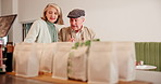 Senior couple, restaurant and counter with food for date, anniversary or valentines day together at indoor cafe. Elderly man, woman or lovers discussing meal choice for hungry appetite at snack bar