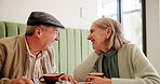 Senior couple, laugh and coffee in cafe for love, marriage and conversation together with connection. Elderly people, happy and talking in restaurant for relax, relationship and romance with bonding