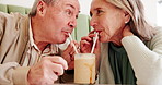 Senior couple, share and drinking with straw for date, romance or delicious smoothie at restaurant. Elderly man, woman or lovers enjoying milkshake, sip or beverage with love at indoor cafe or dinner