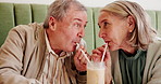 Senior couple, love and sharing drink with straw for date, romance or delicious smoothie at restaurant. Elderly man, woman or lovers enjoying milkshake, sip or cold beverage at indoor cafe or dinner