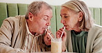 Senior couple, date and drinking with straw for love, romance or delicious smoothie at restaurant. Elderly man, woman or lovers enjoying milkshake, sip or beverage to share at indoor cafe or dinner