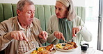 Senior couple, eating and breakfast in cafe for relax, marriage and conversation together with food. Elderly people, hungry and talking in restaurant for love, chat and bonding with bacon and eggs