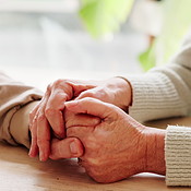 Holding hands, support and senior couple by table for love, empathy or ...