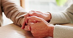 Holding hands, bonding and senior couple by table for love, empathy or forgiveness in marriage. Unity, home and elderly man and woman with connection for trust, loyalty and care for support together.