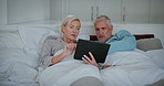 Mature couple, bed and tablet with news app, digital scroll and tech learning with help and support. Talking, social media and online in home with discussion together in bedroom with people and love