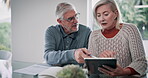 Documents, tablet and senior couple with discussion at table for insurance, financial bills and loan. Elderly people, retirement and home with tech for pension fund, healthcare debt and online budget