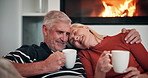 Sofa, senior couple and coffee with hug for love, nostalgic memory and connection with security at home. Happy people, man and woman with tea beverage for bonding, conversation and healthy marriage