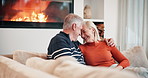 Sofa, forehead touch and mature couple by fire for bonding, relationship and commitment. Home, marriage and happy man and woman embrace on couch for romance, care and relax together in living room