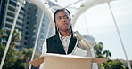 Business woman, fired and sad with box in city with documents, frustrated and unemployed on walk in street. African person, worry and stress with cardboard, package and paperwork on bridge in Kenya