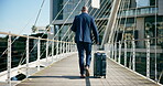 Business, suitcase and back of black man with travel in city for morning, commute and international journey. Corporate, attorney and walking with bag on bridge for legal case, career and outdoor trip