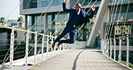 Dance, city and happy business black man excited with good news, career promotion and bonus. Corporate, professional and person in urban town on bridge jump for success, celebration and freedom