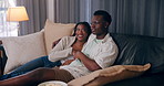 House, funny and black couple on sofa, entertainment and watching tv in living room. African man, woman and humor with comfort, comedy and hobby with movie, film and series with relationship or joke