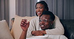 Home, hug and black couple with popcorn, entertainment and watching tv in living room. African man, woman or embrace on sofa, comfortable or hobby with movie, eating and series with snack or marriage