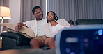 Couple, talking and watching tv on sofa in home with movie review, streaming service and multimedia subscription. Black people, relax and discussion on couch with film broadcast, series and bonding