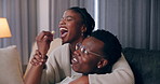 House, eating and black couple with popcorn, entertainment and watching tv in living room. African man, woman and rest on sofa, comfort or hobby with movie, funny and series with relationship or love