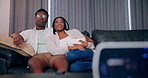 Happy black couple, eating popcorn and projector for movie, show or romantic film in home. Food, man and woman watching tv, talking and relax together on sofa for subscription service in living room