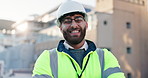 Happy man, civil engineer and helmet with confidence in city for construction, building or architecture on rooftop. Portrait, male person or architect with smile or hard hat for safety in England