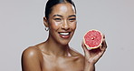 Skincare, fruit and woman in studio, smile and benefits of beauty, shine and confident with product. Spa, white background and portrait of girl with cosmetics, smooth or glow of skin with dermatology