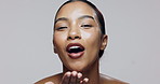 Blow, kiss or face of happy woman in studio with makeup, glow or smile isolated on white background for shine. Flirting, proud or classy model with confidence, cosmetics or beauty skincare results