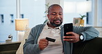 Black man, smartphone and credit card with living room, online shopping and ecommerce. Person, cellphone and payment for review or sales and customer for retail, technology and smile on lounge sofa