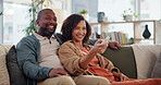 Mature couple, watching tv and remote on sofa with smile, choice and click to change channel for movie. Man, woman and interracial love in home, relax and happy with search, streaming or subscription