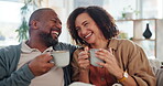 Couple, laughing and cozy with coffee, living room and listening to joke, mature man and woman in home. Lounge, talking and bonding of people, tea and conversation of love in relationship in house