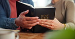 Religion, hands and bible with spiritual, reading and study for peace, worship or faith with coffee. Couple, God and woman with man, christianity gospel or Jesus Christ praise together in home