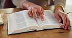 Hands, book and bible study in home for religion, peace or learning on spiritual journey in morning. Person, research or scripture for worship in house, gratitude and search for inspiration in gospel