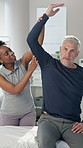 Senior man, physiotherapist and stretching arms with support for recovery, exercise or muscle development. Elderly patient, physical therapy and woman for rehabilitation, injury and help at clinic