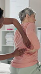 Physiotherapy, senior woman and back pain for exercise, checkup or wellness for health or fitness. Pensioner, female person and medic for assessment, injury or support in rehab clinic or consultation