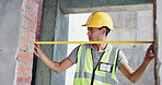 Builder, man and measure door with tape for architecture, maintenance or construction site. Engineer, doorway or check building size with tools for renovation, inspection or frame installation length