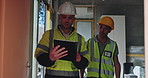 Collaboration, engineer and men with tablet, talking and inspection of property, planning and people in construction. Architecture, project and ideas for design, renovation or maintenance of building