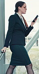 Woman, flight attendant and texting on smartphone with suitcase at airport for departure. Female person, employee and networking with message, notification and social media post as air hostess