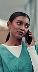 Indian woman, nurse and walking at hospital on phone call for ehealth, telehealth and consultation. Female person, healthcare professional and conversation or communication for medical appointment