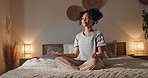 Woman, yoga and lotus on bed, home and happy with peace, mindfulness and relax in pyjamas at night. Girl, person and smile with meditation, zen and balance with breathing in bedroom at apartment