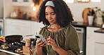 Woman, reading and browsing with phone in kitchen for online recipe or meal preparation at home. Young, female person or chef with mobile smartphone or app for cooking tutorial, ingredients or choice