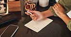 Home, hands and person with paper for shopping list, planning and writing items for grocery by above. Kitchen counter, female writer and page with pen for house needs, reminder and brainstorming