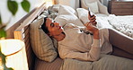 Alarm, lamp and phone with woman in bedroom of home at night for rest or sleep to relax. App, bedtime and social media on mobile with person on bed in apartment for evening browsing or text message