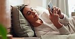 Bedtime, lamp and phone with happy woman in bedroom of home at night for rest or sleep to relax. Alarm, app and social media on mobile with smile of person on bed for evening browsing or text message