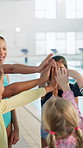 Group, hands or happy kids high five for swimming at school for sports fitness, aquatic learning or success. Goal, team or instructor with children for performance target or skill development in pool