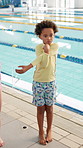 Child, stretching and ready at pool for lesson, learning and swimming class in school gym. Kids, warm up and arm exercise in physical education for development, coordination skills or growth at water