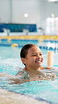 Girl, child and noodle in swimming pool for learning, stroke and excited with development, wellness or training. Kid, exercise and fitness at class with safety, progress and balance for water sports