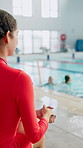 Woman, lifeguard and children in pool at swimming lesson, development or training for safety. Girl, back and teacher with kids in water, float and stroke for practice, progress or learning with sport