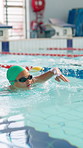 Girl, child and race in swimming pool for competition, stroke and speed with development, wellness or training. Kid, exercise and fitness at class with safety, progress and contest for water sports