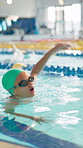 Girl, child and race in pool for competition, swimming and speed with development, wellness or training. Kid, exercise and fitness at class with safety, progress and fast in contest for water sports