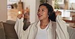 Happy woman, relax and dancing with headphones on sofa for music, streaming or listening to song at home. Young, energy or female person with smile in joy for podcast, radio or sound track at house