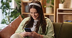 Home, typing and woman on sofa, cellphone and typing with message to contact, network and chatting. Smartphone, person or girl on couch, mobile game and online reading with break, smile or connection