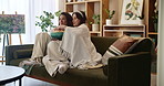 Couple, lesbian and popcorn in house for movie, television and streaming online video with subscription. Women, couch and eating snack in living room for watching tv, bonding and relax with blanket