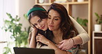 Mother, daughter and hug with laptop in house for remote work, affection and bonding at dining table. Kiss, woman and girl with embrace in lounge for connection, relationship and support in apartment